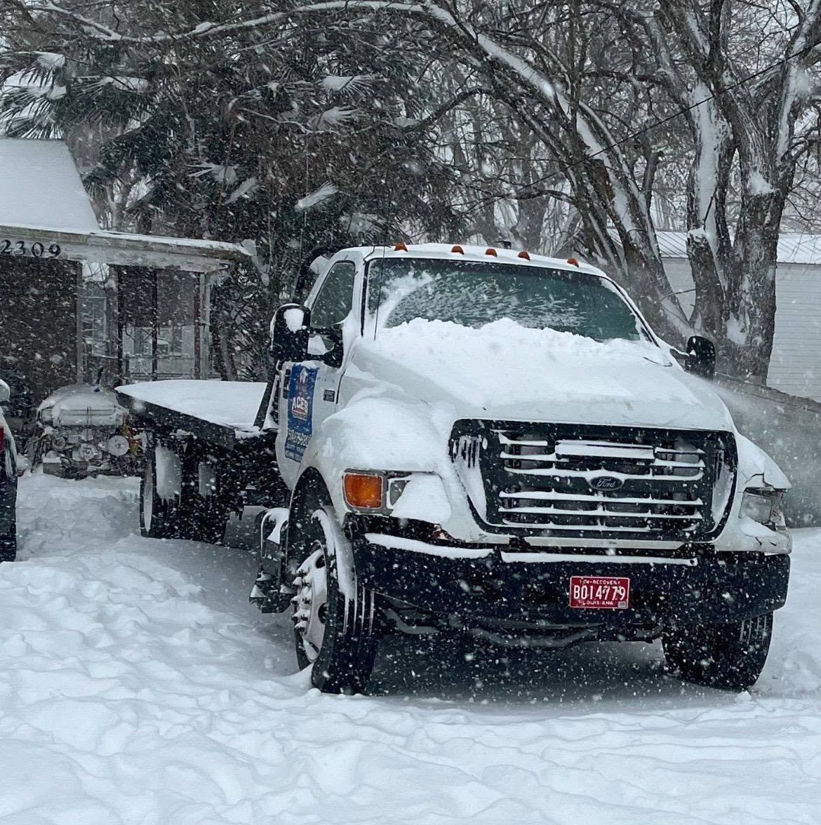 Aces Towing truck covered in snow